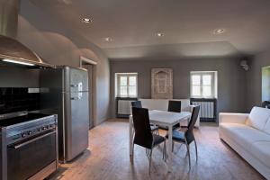 cocina con mesa blanca y sofá blanco en Villa Margherita appartamento per 5 in Villa ottocentesca, en Castiglione Chiavarese