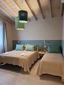 a room with two beds and a ceiling at Padre Relais di Campagna in Collemezzano