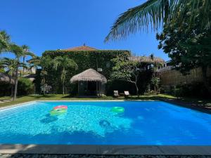 a swimming pool with two balls in the water at KUTA - 4BR Villa with Private XL Pool in Kuta