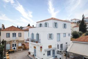 an aerial view of a white building in a city at Old Port Spetses Mansion in Spetses