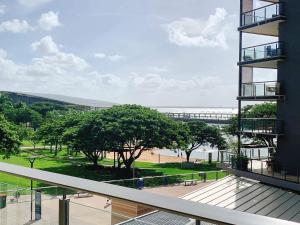 a balcony of a building with a view of a park at Darwin Waterfront Luxury Condo in Darwin