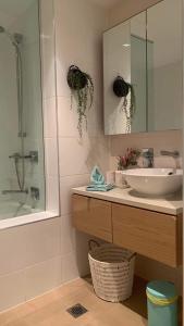 a bathroom with a sink and a mirror at Darwin Waterfront Luxury Condo in Darwin