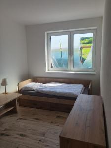 a bedroom with a bed and a window at Sunset House Piešťany Červená Veža in Banka