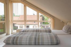 a bedroom with two beds and a large window at Ferienwohnung beim Europa-Park Rust in Rust