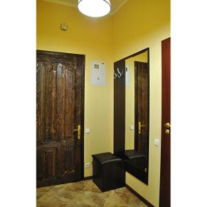 a hallway with two doors and a black leather seat at Pushkinskaya street in Kharkiv