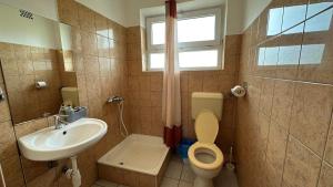 a bathroom with a toilet and a sink at THERMÁL vendégház in Sárospatak