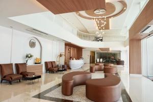 a lobby with leather chairs and a waiting room at M CASA HOTEL PATTAYA in Pattaya South