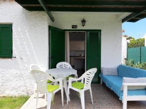 a patio with a table and chairs and a couch at bungalow with private garden in Playa del Ingles