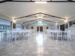 a room with white tables and chairs in it at Thuto Centre Conferencing & Bush Lodge in Bela-Bela
