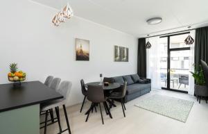 a living room with a couch and a table at Pärnu Verde Apartments in Pärnu