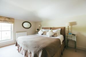 a bedroom with a large bed and a window at The East End Arms in Lymington