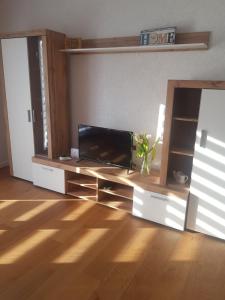 a living room with a flat screen tv on a table at Vila Haris in Sarajevo