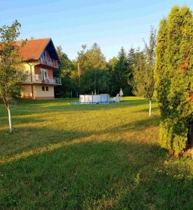 a house in the middle of a field with trees at Vila Haris in Sarajevo