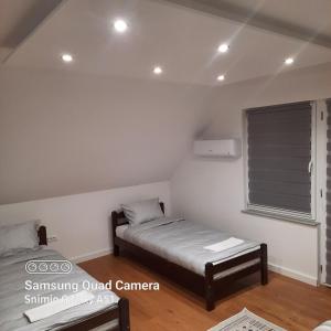 a small room with two beds and a window at Vila Haris in Sarajevo +14 photos