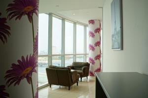 a living room with a chair and a window at Luxurious Penthouses in Dubai