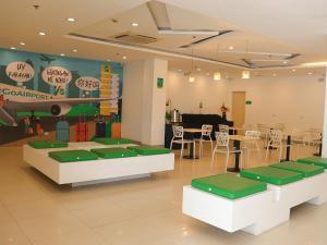 a restaurant with tables and chairs and a piano at Go Hotels Manila Airport Road in Manila