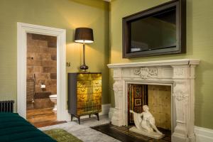 a living room with a fireplace with a tv above it at Number 31 in Dublin