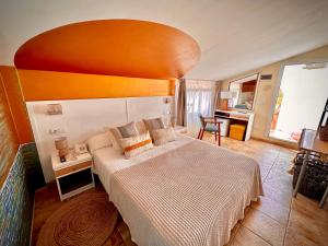 a bedroom with a large bed with an orange headboard at La Muntanya in Llafranc