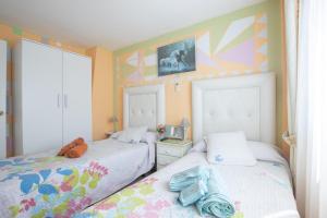 two beds in a room with colorful walls at gcprestige in Estepona