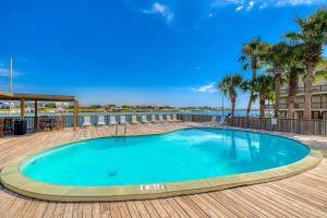 a swimming pool on a deck with palm trees at Lei Lani Village 110 in Orange Beach