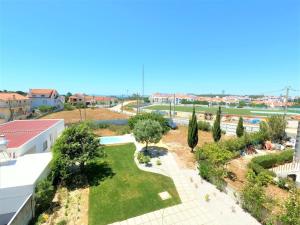 a view of a park from a building at Caparica traditional V4 duplex apartment with pool Charneca da Caparica Lisboa in Barriga