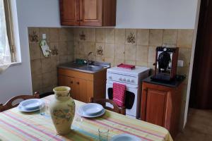 una cocina con una mesa con un jarrón. en Appartamento vista mare, en Nicotera Marina