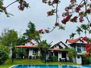 a house with a pool in front of it at La Y Riverview in Hue