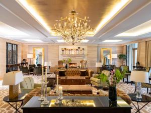 a living room with a couch and a chandelier at The Europe Hotel & Resort in Killarney