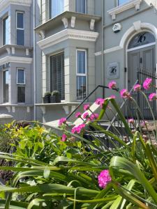 a house with pink flowers in front of it at Number 46 in Hastings