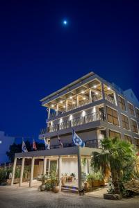 a building with flags on it at night at Sahara Hotel Eilat in Eilat