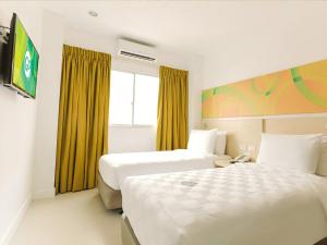 Rúm í herbergi á Go Hotels Timog