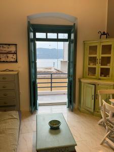 una sala de estar con una puerta que da a un balcón en Almira Studios and Apartments, en Agia Marina