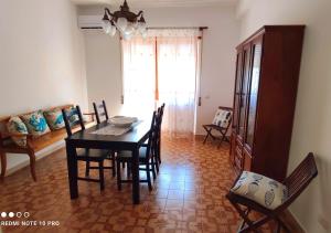 a dining room with a table and chairs at Casa Sara in Gaeta