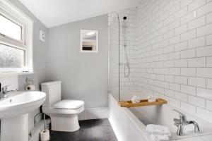 een witte badkamer met een toilet en een wastafel bij Elegantly 2-Bedroom in Ashington, Sleeps 3 in Ashington