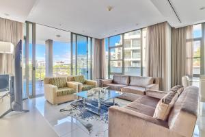 a living room with couches and a glass table at Lawhill Luxury Apartments - V & A Waterfront in Cape Town