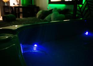a hot tub with blue lights in a living room at 2Bulles in Saint-Mamet