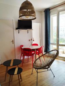 uma sala de jantar com uma mesa e cadeiras vermelhas em LA TERRASSE DE NOTRE DAME em Le Havre