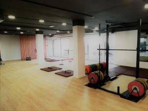 a gym with dumbbells in a large room at Pine Cliff Apartment by The Portuguese Butler in Olhos de Água