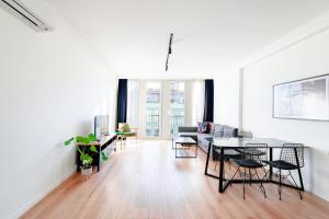 a white living room with a table and chairs at Homie Suites - Luxury Apartments in Maçka in Istanbul