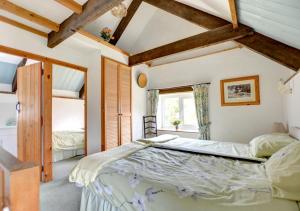 a bedroom with a large bed in a room at The Stables in Whitland