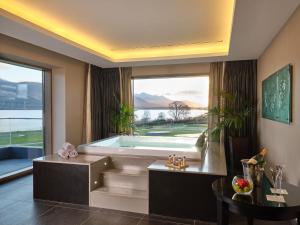 a large bathroom with a tub and a large window at The Europe Hotel & Resort in Killarney