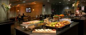 a buffet line in a restaurant with fruits and vegetables at Cabinn Metro in Copenhagen