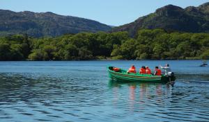 a group of people in a boat on a lake at The Europe Hotel & Resort in Killarney