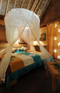 מיטה או מיטות בחדר ב-Green Lodge Moorea