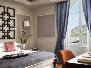 a bedroom with a bed and a window at Vista Palazzo - Small Luxury Hotels of the World in Como