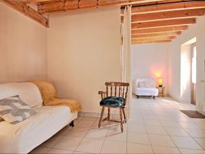 a bedroom with a couch and a chair in a room at Holiday Home Moulin Bastard by Interhome in Le Croisic