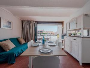 a living room with a table and a couch at Holiday Home Les Brigantins-1 by Interhome in Port Leucate