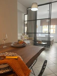 a dining room with a table and a living room at Jelinas bright apartment in the centre of Nafplio in Nafplio