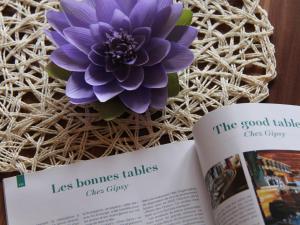 a book with a purple flower on the pages at Apartment Le Geteillon 4 by Interhome in Chesières +22 photos