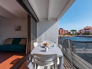 a table on a balcony with a view of the water at Holiday Home Les Brigantins-1 by Interhome in Port Leucate